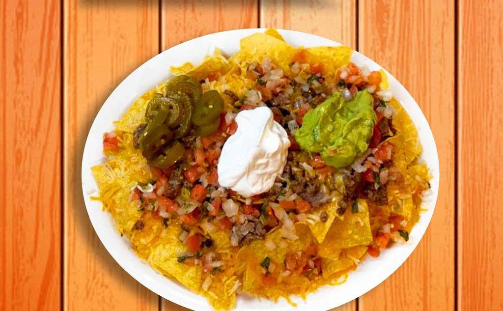 Nachos Supreme · Warm corn tortilla chips, with your choice of meat, beans, melted cheese, pico de gallo, sour cream, fresh guacamole, and sliced jalapeños.