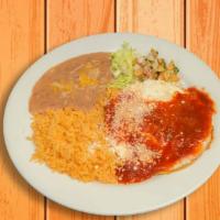 Huevos Rancheros · A plate of two eggs over a corn tortilla, covered in salsa Roja and cotija cheese. Served wi...