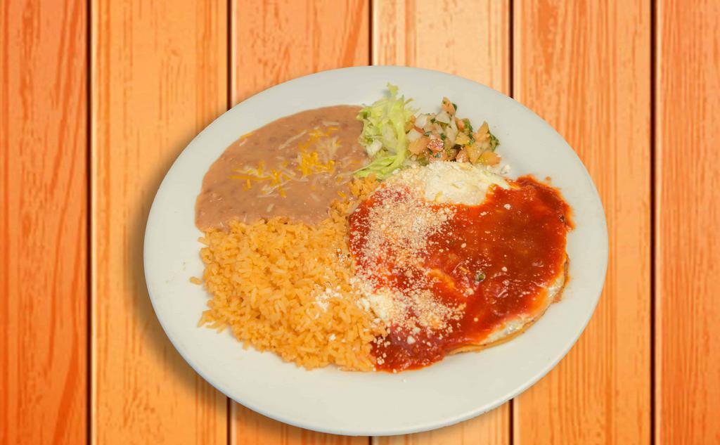 Huevos Rancheros · A plate of two eggs over a corn tortilla, covered in salsa Roja and cotija cheese. Served with rice and beans.