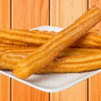 Churros · 2 long deep-fried pieces of dough filled with cajeta, a Mexican-style caramel, sprinkled wit...
