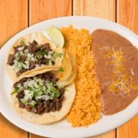Kids' Tacos Plate · Two tacos topped with your choice of chicken or beef served with cilantro, onions, your choi...