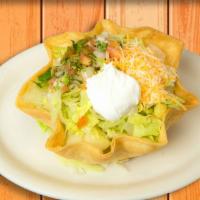 Taco Salad · Flour tortilla shell filled with rice and beans, your choice of chicken or ground beef, shre...