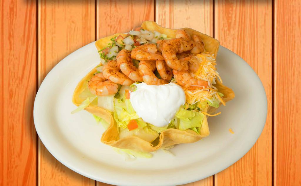 Shrimp Taco Salad · Flour tortilla shell with rice and beans, lettuce, cheese, pico de gallo, sour cream, topped with savory grilled shrimp.