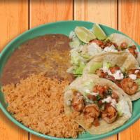 Shrimp Tacos Plate · Three corn tortillas, topped with grilled shrimp, shredded lettuce, pico de gallo, and house...