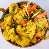 Aloo Gobi · Potatoes and cauliflower cooked with onions, tomatoes and spices.