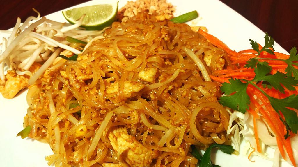 Pad Thai · Stir-fried rice noodle with eggs, bean sprouts, green onion and tamarind sauce, with a side of ground peanuts and lime