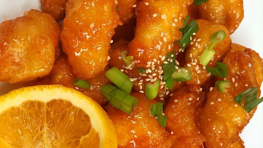 Thai Orange Chicken · Marinated orange chicken lightly battered and fried with a tangy Thai orange sauce, served with onions, green onions and orange slices