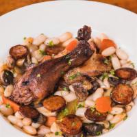 Cassoulet · A classic French stew with duck confit, sausage, braised chicken, vegetables, white beans an...