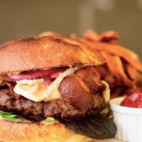 Burger · Topped with bacon & brie served on a brioche bun with a side of fries.