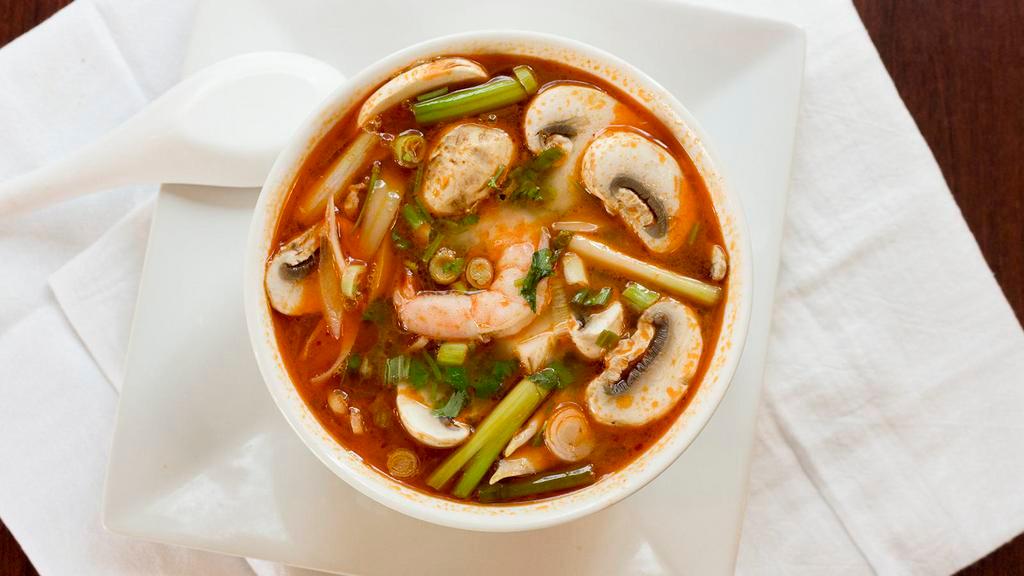 Tom Yum · Hot and sour mixed with lemongrass, galangal root, onions, tomatoes, lime leaves, mushrooms, and cilantro.