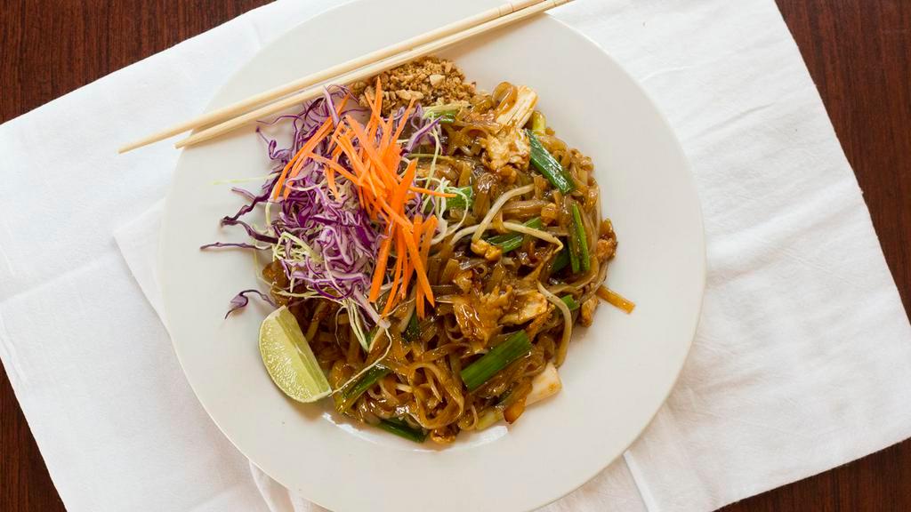 Pad Thai · Thin rice noodles stir fried with egg, green onions, bean sprouts, and mixed with a sweet and tangy sauce, topped with crushed peanuts.