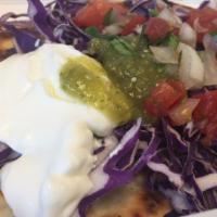 Chilquiles · Your choice of topping with a fried egg, salsa verde, crema, cilantro, onion, a side of sals...