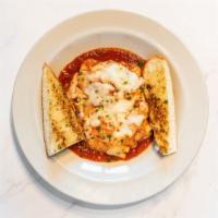 Lasagna · Classic baked lasagna with meat sauce served with garlic bread