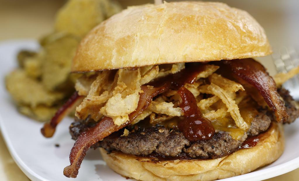 Krusty · Peppercorn-crusted, BBQ sauce, bacon, cheddar, onion strings, ketchup. Served with your choice of side.
