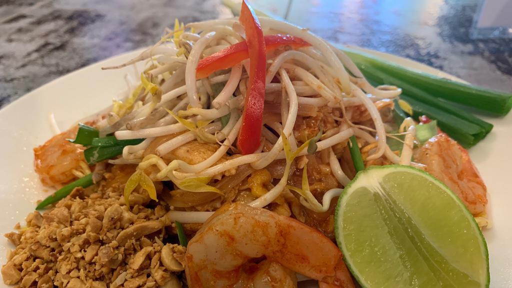Pad Thai · Rice noodles stir-fried with egg, green onions, bean sprouts, in house tamarind sauce. Comes with lime and peanuts.
