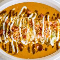 Smothered Burrito · Comes with green Chile cheese sauce, lettuce, tomatoes, sour cream and green or red salsa on...
