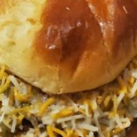 Green Chili Slopper · 1/4 pound burger smothered in our homemade green chili topped with shredded cheese.