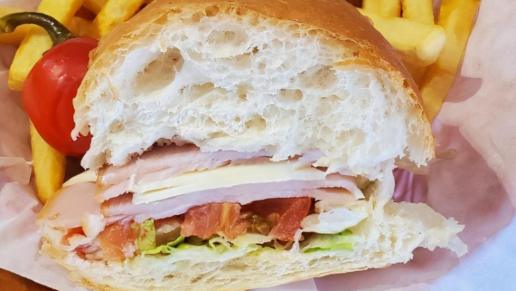 Half Turkey And Swiss · Freshly sliced Turkey served on a mini loaf with mayo, lettuce and tomato. Your choice of Grilled or Cold.