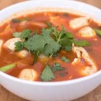 Tom Yum Soup · Clear spicy soup with a touch of lemongrass, galangal root, kaffir leaves, tomatoes, onions,...