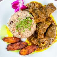 Curried Goat · With rice or roti, and a side of either potato salad, plantains, mashed potato or mac & chee...