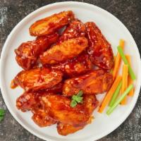 Vegan Bully Buffalo Chicken Wings · Vegan chicken wings breaded, fried until golden brown, and tossed in buffalo sauce. Served w...