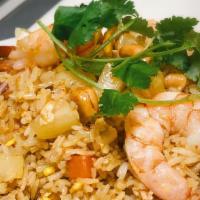 Pineapple Fried Rice · Rice stir-fried with pineapple, egg, peas, carrots, onion, cashew nuts, a dash of yellow cur...
