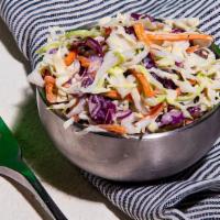 The Other Side Coleslaw · Shaved Cabbage and Carrots.