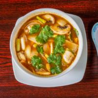 Tom Yum Soup · Spicy herb soup infused with lemongrass, lime leaves, galangal, onion and mushroom.