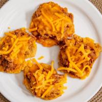 Side Tostones (4 Pieces) · Tostones are crispy, hash brown-like rounds that are made from green plantains and then slic...