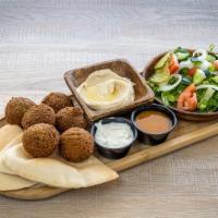 Flafal  · Six pieces of falafel served with hummus, a side salad and turmeric Sauce (Amba), or tazziki