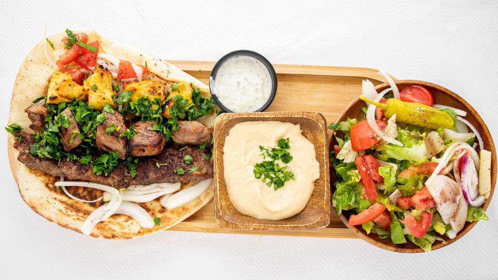 Mix Plate  · One skewer of chicken tikka, one skewer of meat tikka, and one skewer of kabab, served with salad, and hummus