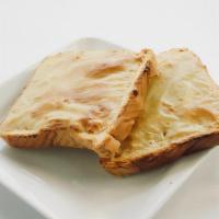 Cheese Bread · Fresh baked bread topped with sweet house made cheese