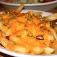 Chile Cheese Fries · A mound of French fries smothered with melted cheese and topped with your choice of red or g...