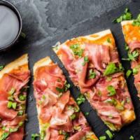 Prosciutto De Parma Pizza · Mounds of prosciutto and mozzarella are topped with fresh arugula, Parmigiana Reggiano, and ...