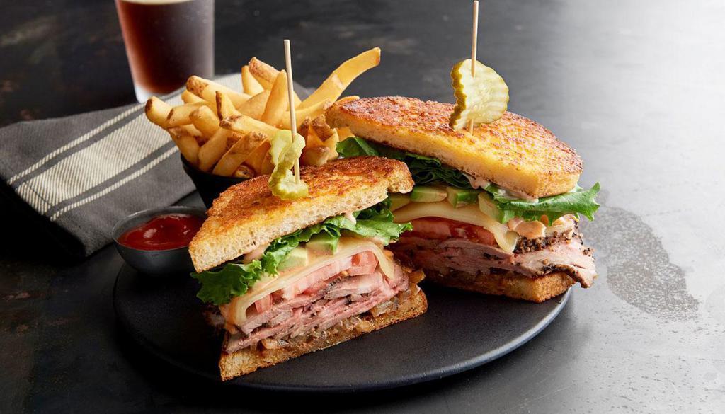 Cali Tri-Tip Sandwich · Slow-roasted tr-tip, provolone cheese, avocado, tomatoes, lettuce, Thousand Island dressing and chipotle mayo served on grilled Parmesan bread.