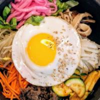 Bibimbap  비빔밥 · Bowl of warm rice topped with sauteed and seasoned carrots, mushrooms, bean sprouts, beef bu...