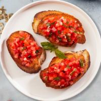Bruschetta · Organic home baked bread topped with ripe tomatoes, fresh basil, olive oil and Parmesan chee...