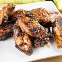 Jerk Chicken Wings · Chicken wings grilled in our homemade jerk seasoning, topped with our sweet fire jerk sauce....