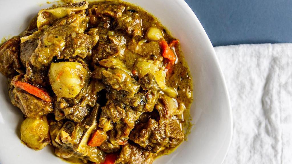Curry Goat. · Goat meat simmered in flavorful curry.