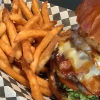 Texas Burger · 1/3 lb. cheeseburger with bacon and ham and fried egg served with lettuce, tomato and a onio...