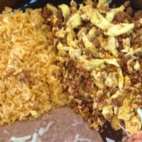 Huevos Con Chorizo · Three eggs scrambled with homemade Mexican sausage served with rice and beans and homemade c...