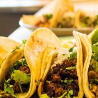 Traditional Tacos · Corn tortillas, your choice of meat, hot salsa, garnished with onions and cilantro.