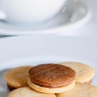 Tea Cookies · Small shortbread cookies sandwich a smooth and creamy layer of hazelnut ganache or dark choc...
