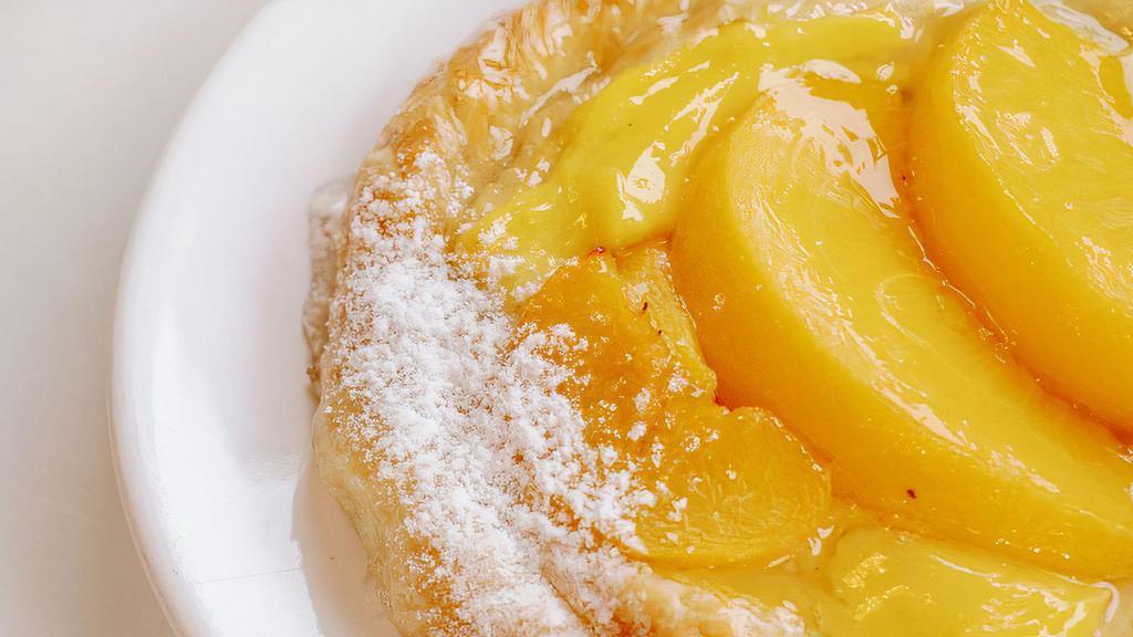 Peach Danish Roll · This flaky pastry is lightly sweetened with a pastry cream filling and peaches
