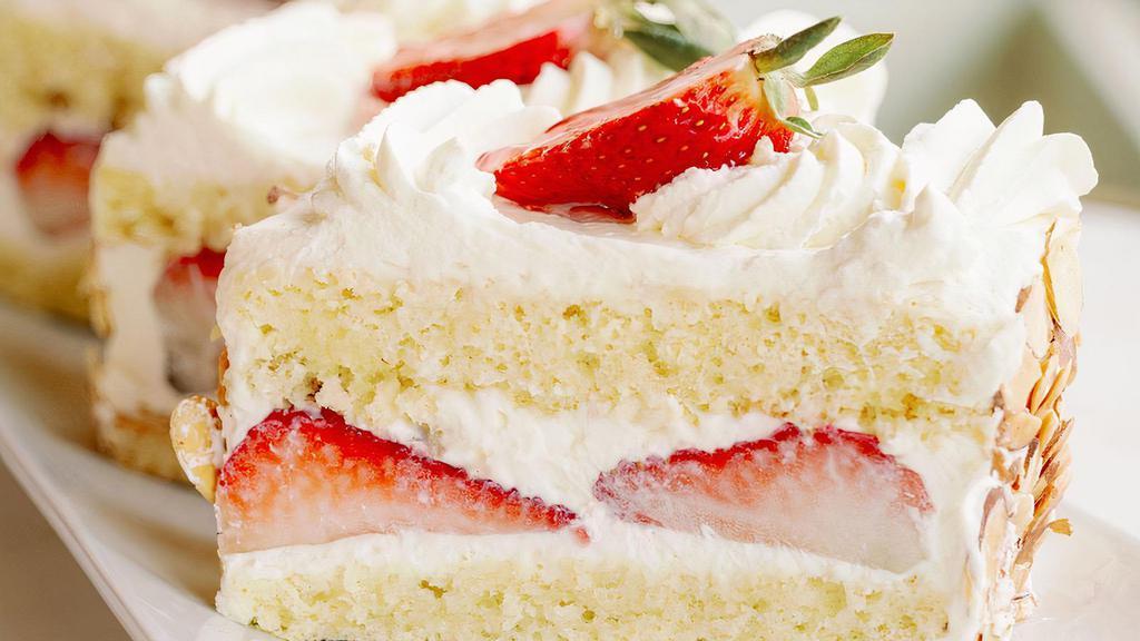 Strawberry Cake · Two layers of moist white genoise soaked in Kirsch, divided by layers of fresh strawberries and whipped creme. This is then topped off with whipped creme and almonds. Allergy Warnings: Contains gluten and almonds.