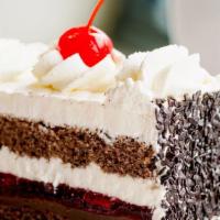 Black Forest Cake · Two layers of chocolate genoise soaked in Kirsch, divided by layers of chocolate ganache, ch...