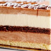 Trio Of Mousse · Smooth layers of chocolate and vanilla mousse divided by a layer of almond and chocolate bis...