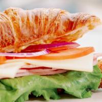 Ham And Swiss Croissant Sandwich · Ham, swiss cheese, onion, lettuce, mayonnaise, Dijon mustard and tomato served on a croissant