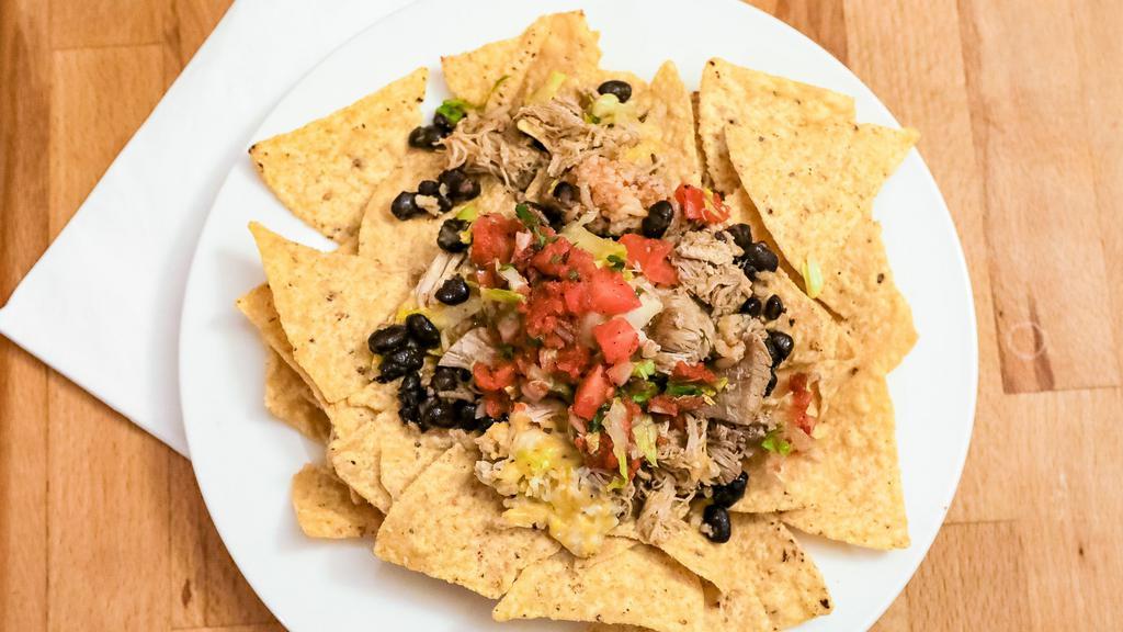 Pica Pica Chips · Crispy corn chips, your choice of Meat, comes with black beans, salsa, sour cream, shredded cheese.