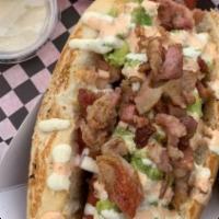 Sonora Hot Dog · Sausage with bacon, beans, chorizo, guacamole, fried onion, and special dressing. Pickles an...